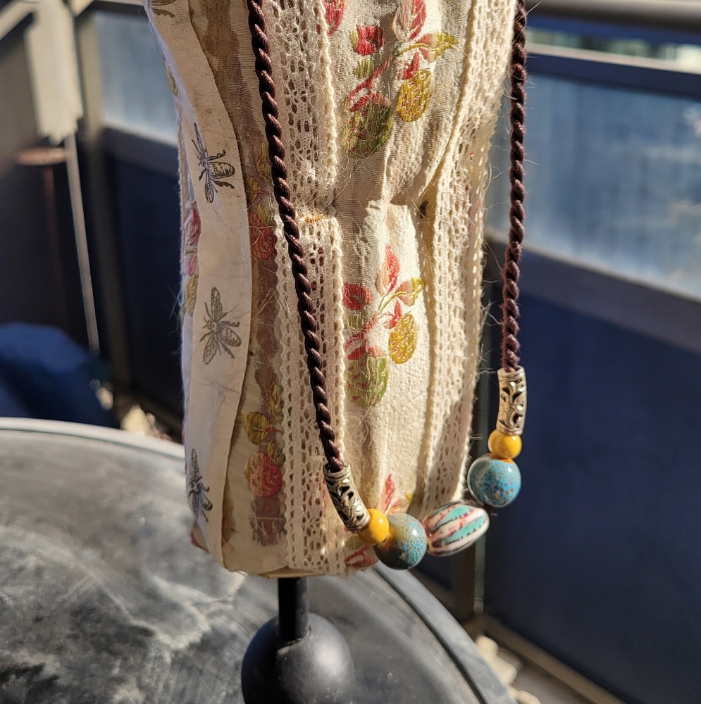 2/$22 Ceramic artisan bead necklace on twisted brown cord